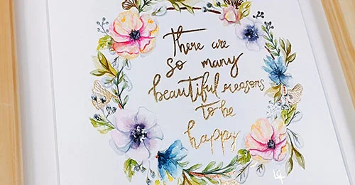 Drawing of flowers arranged in a circle around gold text that reads 'There are so many beautiful reasons to be happy'