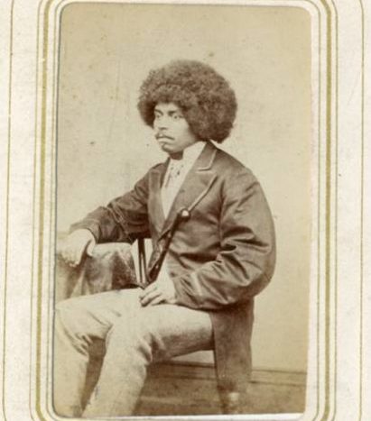 Black and white photograph of a seated black man