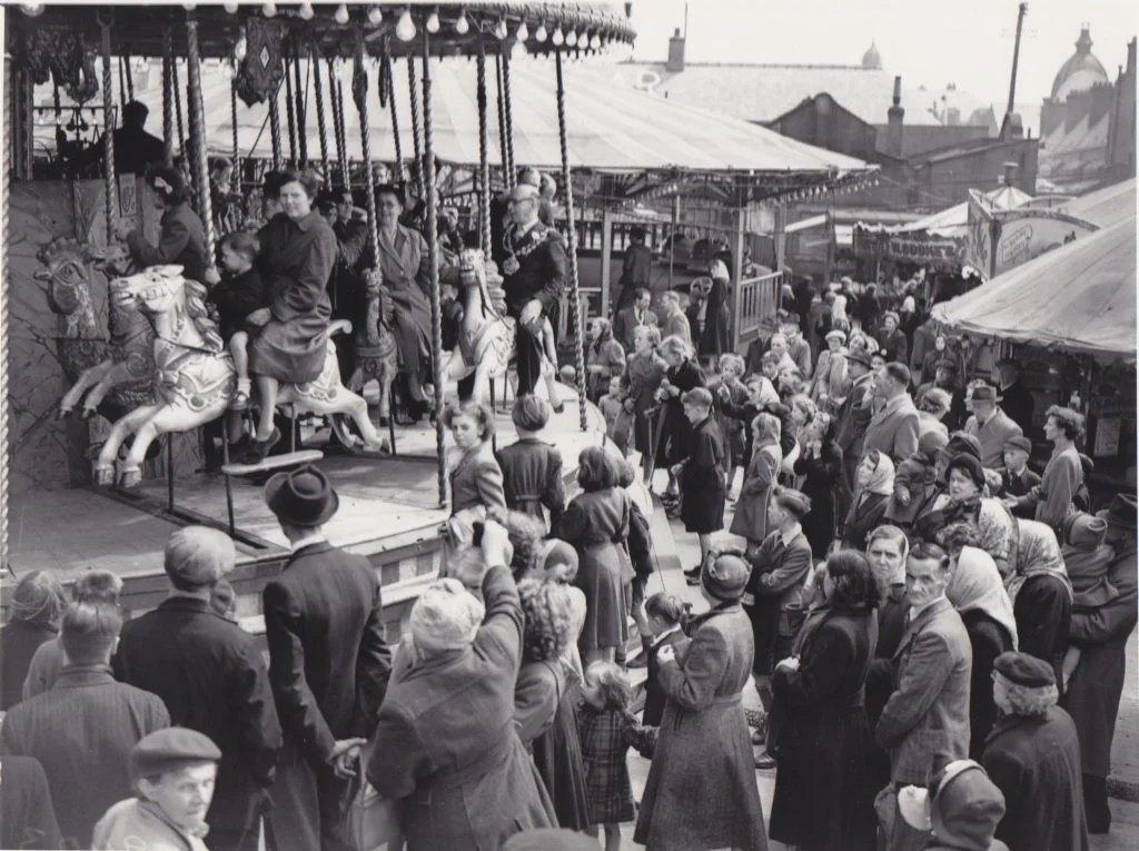 Photograph of people riding a carousel at the Oldham Wakes Fair on Tommyfield Market, Oldham.
Image reference: P8987