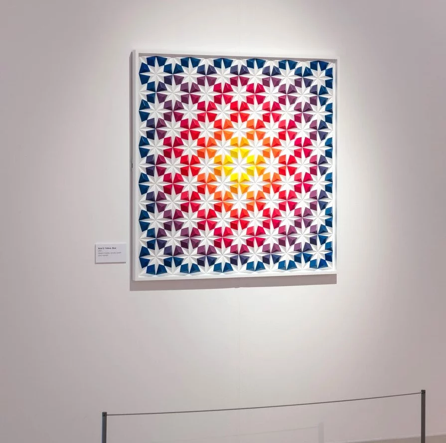 Image of Root 2: Yellow, Blue by Zarah Hussain a geometric artwork shown on a gallery wall.
