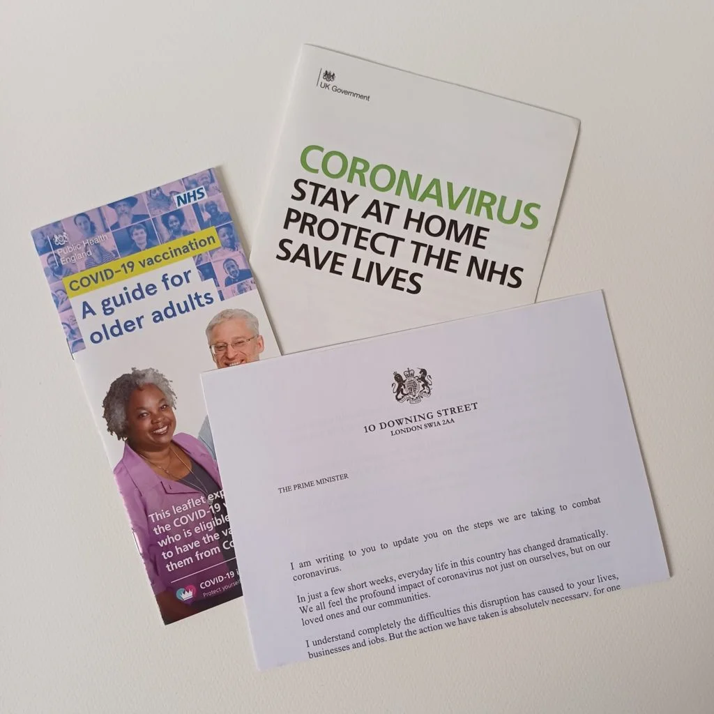 Three government documents: A letter sent by the Prime Minster, a leaflet on how the elderly could receive their first dose of the vaccine and the Stay at Home leaflet.